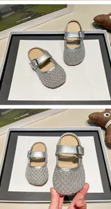 Close-up of silver hollow mesh girls' breathable summer slippers with buckle strap