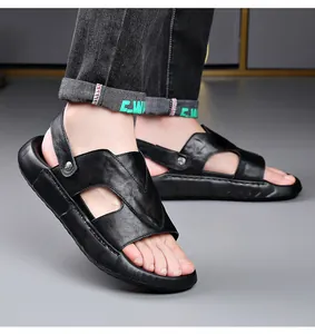 Detail view of stylish men's black leather sandals with thick soles worn by model