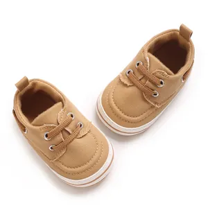 Detailed top view of comfortable tan canvas baby walking shoes with durable white rubber soles