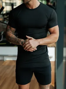 Slim fit men's black sports T-shirt showing muscle definition and elastic fabric