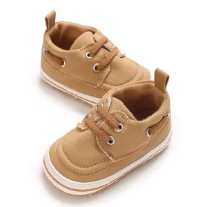 Close-up detail of soft brown baby canvas walker shoes featuring durable lace-up design