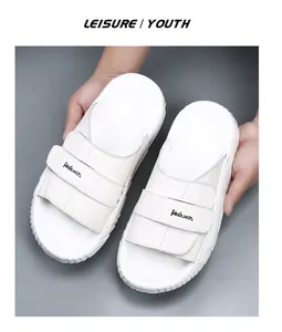 Detail showing the white leather texture and double straps of these premium men's summer sandals