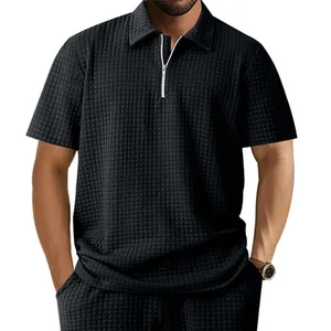 Detail view of men's heavy black waffle jacquard texture quarter-zip polo shirt and collar