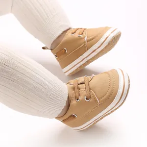 Close-up of khaki canvas baby walking shoes with white soles for infants aged 0-1 year