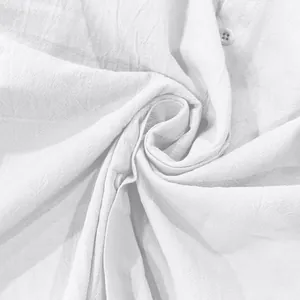 Macro view showing the breathable white linen fabric texture of a casual men's shirt
