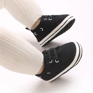 Detailed view of black canvas baby walker shoes with non-slip soles for infants