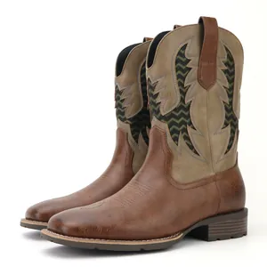 Close-up side view of men's vintage brown western cowboy boots featuring colorful embroidery.