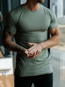 Tight-fit olive green athletic t-shirt showing muscle definition and fabric texture