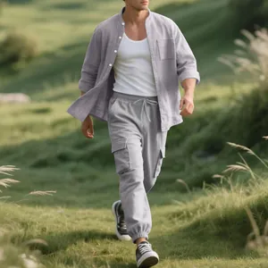 Full view of men's lavender linen set worn by a model in a natural outdoor meadow.