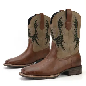 Detailed view of men's vintage western cowboy boots with olive green embroidered shaft
