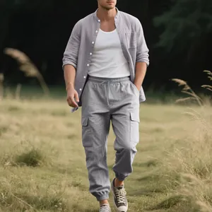 Full body view of a man wearing a casual gray linen shirt and cargo jogger set