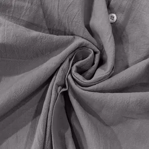 Detailed macro shot showcasing the natural grey linen shirt fabric texture and button details