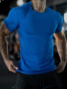 Close-up of blue stretch athletic T-shirt showing muscle-fit tailoring and texture