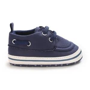 Side view of navy blue canvas infant walking shoe featuring a white non-slip rubber sole