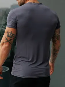 Rear view of a men's tight grey athletic t-shirt showing its stretchable fit and fabric