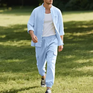 Men's light blue linen shirt and cargo joggers set in a natural outdoor park setting