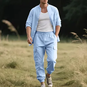 Men's light blue linen shirt and cargo pants two-piece set worn in an outdoor field