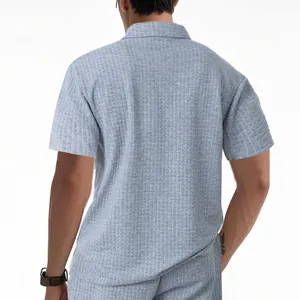 Rear detail view of men's heavy jacquard textured polo shirt in light grey