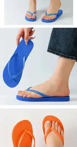 Detailed view of fashionable flat flip-flops in vibrant blue and orange colors
