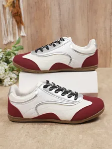 Side view detail of women's retro color-block German trainers with silver accents.