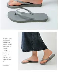 Side view of grey minimalist fashion flip-flops on feet for stylish summer outdoor wear
