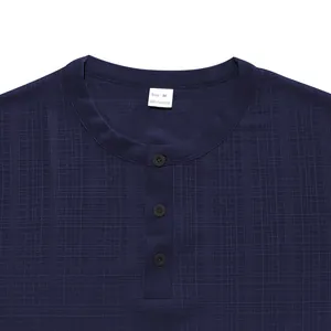 Close-up of Henley collar and slub texture on men's navy blue t-shirt