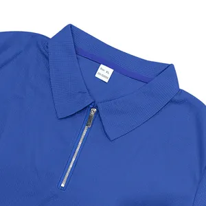 Détail d'un polo bleu en maille gaufrée avec col zippé et étiquette taille XL