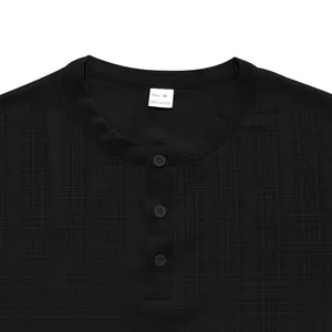 Detailed view of black slub fabric and button placket of a men's Henley T-shirt