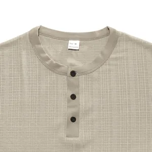 Detail view of a men's slub texture Henley shirt with three black buttons.