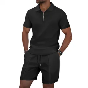 Detailed view of men's black waffle knit polo shirt with zipper and matching shorts