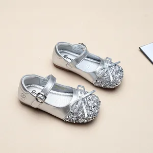 Close-up of silver sequined Mary Jane princess shoes for girls with bow detail