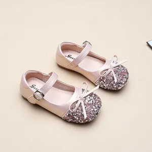Close-up of elegant pink glitter princess shoes for little girls featuring a bow accent