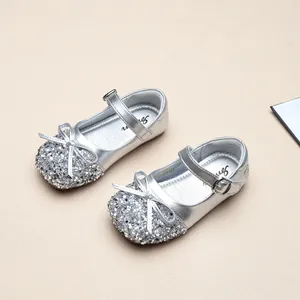 Detailed view of silver sequin princess shoes for girls featuring a bow and buckle strap
