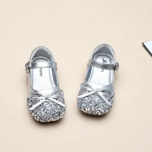 Close-up of sparkling silver sequins and bow detail on toddler princess shoes