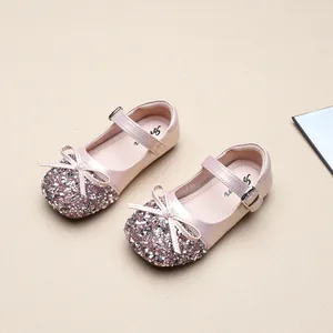 Close-up of pink sequin girls' princess shoes with bow detail and Mary Jane strap