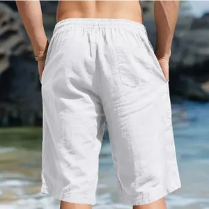 Back view of men's white cotton-linen beach shorts with elastic waist and pocket.