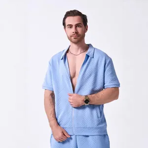 Detailed view of men's light blue zip-up shirt featuring 3D textured jacquard pattern