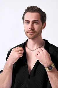 Detailed view of the textured black jacquard fabric on a men's zip-up cardigan