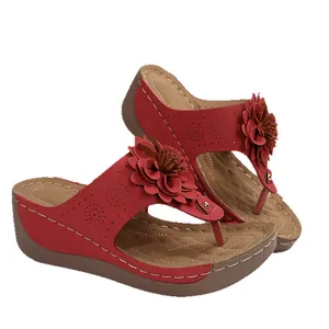 Red wedge flip-flop sandals for women with elegant floral decoration and open toe design