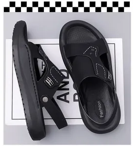 Close-up view of black men's sandals with decorative white stitching and soft soles