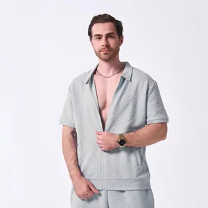 Detail shot of men's casual light blue short sleeve zip-up shirt with jacquard texture