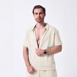 Detail view of men's beige jacquard zip cardigan and shorts set with textured fabric