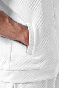 Close-up detail of white jacquard fabric and pocket on men's casual outdoor jacket