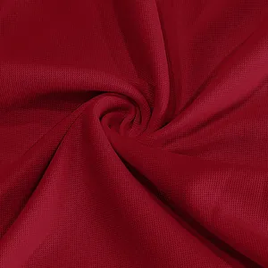 Macro detail of burgundy breathable pique fabric texture for quick-dry polo shirt