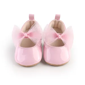Vista frontal de zapatos de princesa para bebé en color rosa con grandes lazos
