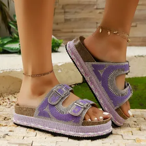 Detailed view of purple rhinestone platform sandals with cork soles and double buckles