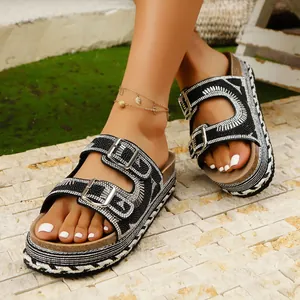 Detailed view of black platform sandals featuring sparkling rhinestones and double buckles.