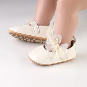 Detailopname van crème baby prinsessenschoenen met een elegante kanten strik