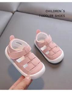 Pink hollow toddler sandals with soft white soles and velcro straps for baby walking