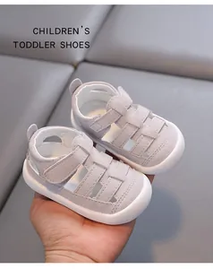 Close-up of minimalist grey toddler sandals with hollow-out design and protective toe cap